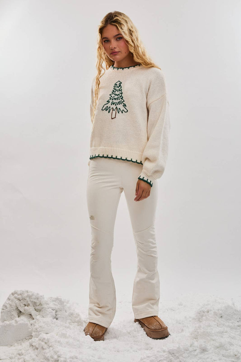 Cozy oversized cream sweater featuring a festive green Christmas tree embroidery, perfect for Long Island boutique fashion this holiday season.