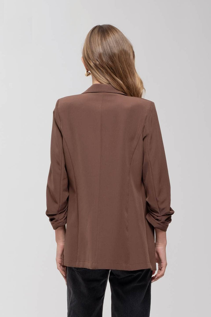 Stylish 3/4 ruched sleeve blazer in rich brown, featuring a tailored fit perfect for versatile Long Island boutique fashion.
