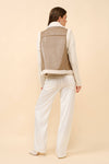 Faux leather moto jacket vest in beige with shearling trim, perfect for layering in stylish Long Island boutique fashion.