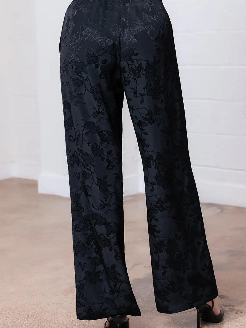 Stylish black floral straight leg pants featuring an elegant pattern and comfortable fit, perfect for Long Island boutique fashion.