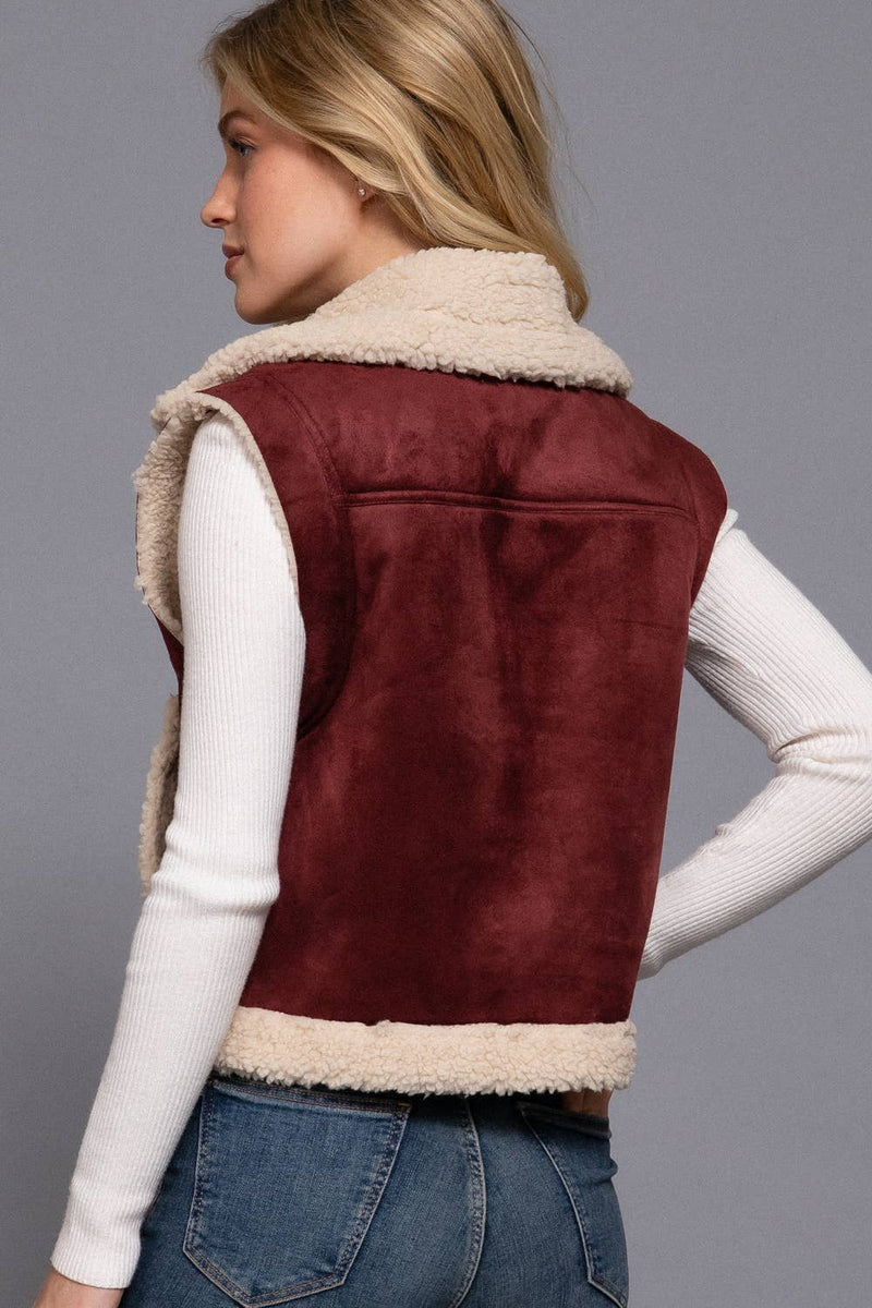 Cozy faux suede zip-up vest in rich burgundy with a soft inner fur lining, perfect for stylish layering in Long Island boutique fashion.
