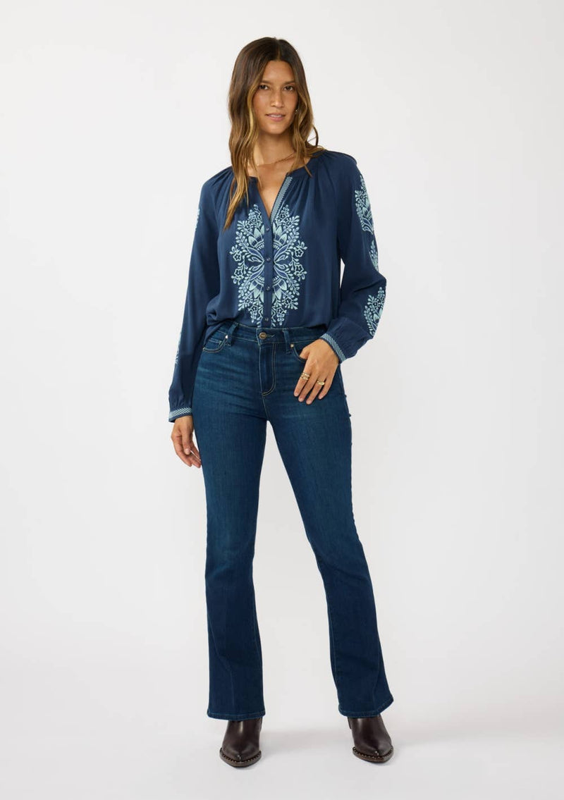 Navy embroidered raglan button blouse featuring floral patterns, paired with fitted jeans for a chic Long Island boutique fashion look.