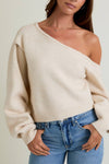 Cozy asymmetrical shoulder sweater top in soft beige, featuring a relaxed fit and ribbed hem, perfect for Long Island boutique fashion.