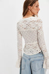 Delicate long sleeve top featuring intricate white lace, fitted silhouette, and flared sleeve details, perfect for Long Island boutique fashion.