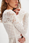 Delicate white lace long sleeve top with bell sleeves, perfect for layering in chic Long Island boutique fashion.