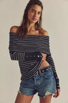 Off-the-shoulder black and white striped sweater with buttoned sleeves, styled with denim shorts, perfect for Long Island boutique fashion.