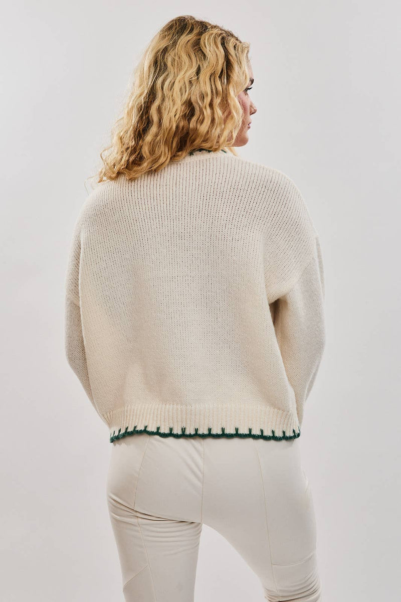 Oversized cream sweater featuring festive "Christmas Tree" stitching and a green trim, perfect for cozying up in Long Island boutique fashion.