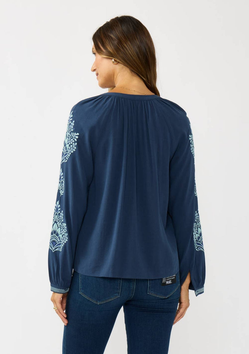 Navy blue embroidered raglan button blouse with delicate floral patterns on the sleeves, perfect for Long Island boutique fashion.