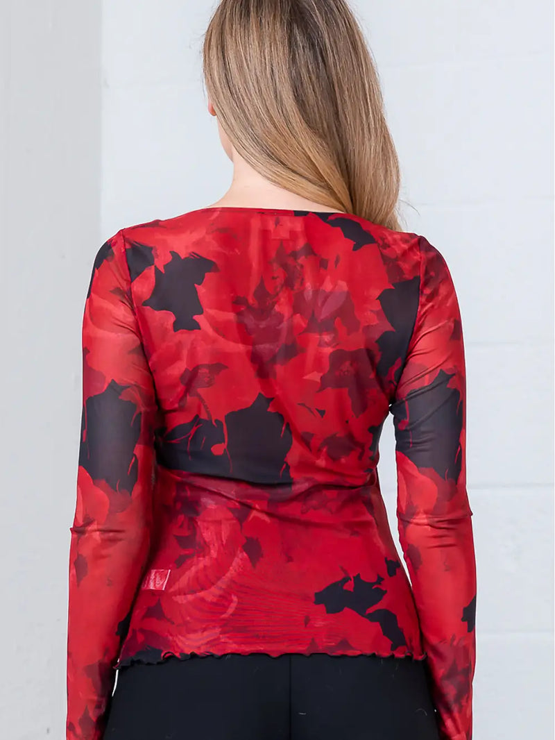 Long sleeve, boat neck top in a sheer mesh fabric featuring a vibrant red floral print, perfect for Long Island boutique fashion.