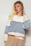 Colorblock distressed denim patchwork knit sweater features soft pastel hues, frayed edges, and a relaxed fit for a trendy Long Island boutique fashion look.