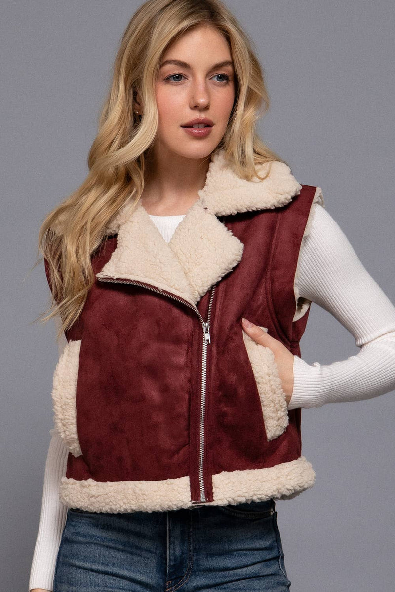Faux suede zip-up vest in rich burgundy with plush inner fur lining and cozy side pockets, perfect for Long Island boutique fashion.