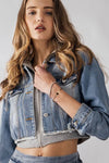 Edgy distressed zip front hybrid denim jacket in light wash, featuring a cropped fit and hoodie detailing, perfect for Long Island boutique fashion.