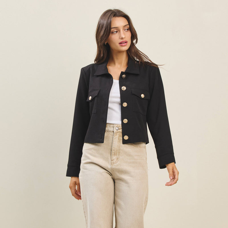 Chic black flap-pocket jacket featuring a cropped fit and gold button details, perfect for Long Island boutique fashion enthusiasts.