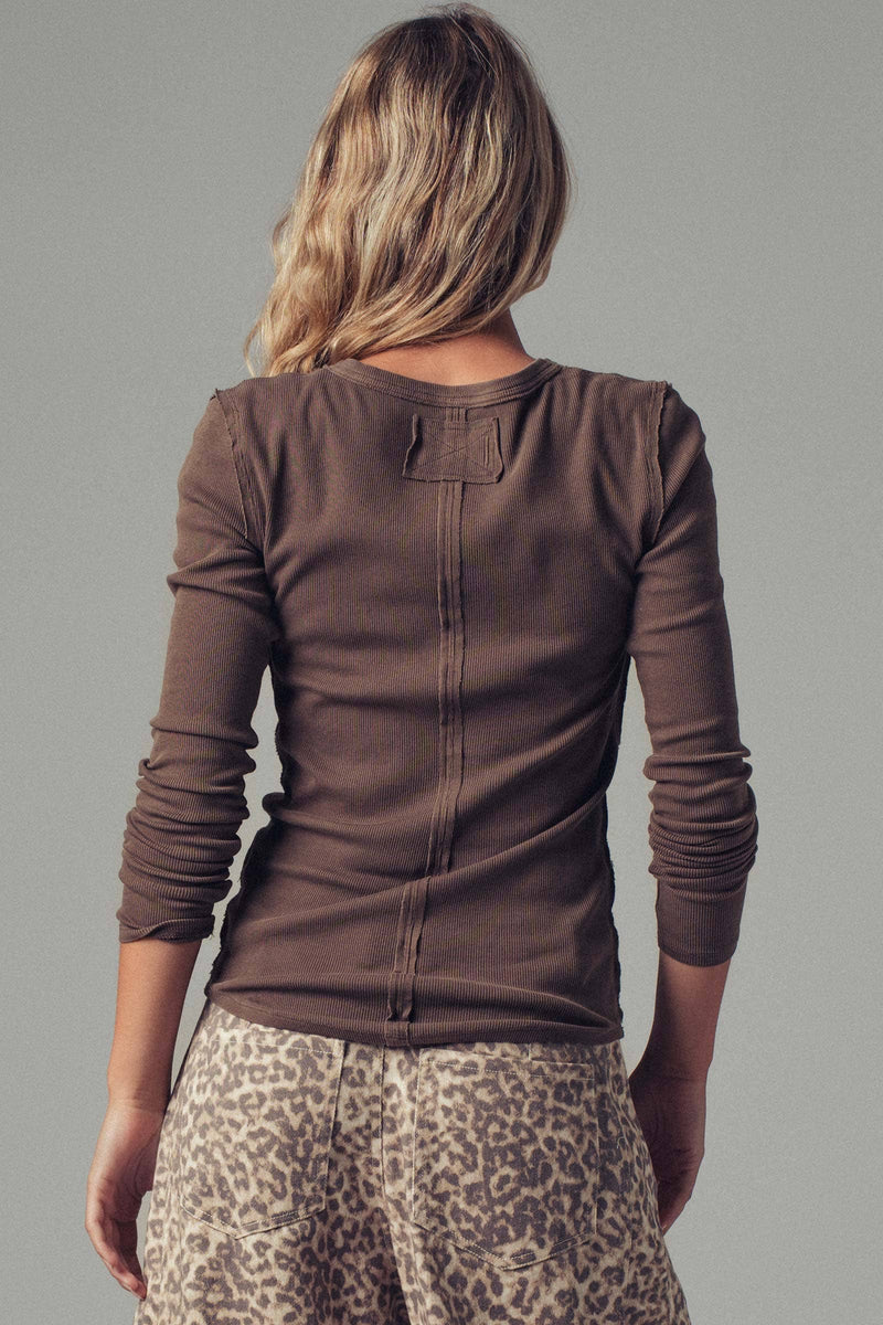 Model wearing brown ribbed Henley long sleeve top with button-up neckline — fitted everyday tee available at TandyWear Boutique in Commack, NY. back view