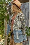 Camo and denim blend in this oversized woven jacket, featuring a floral patch and frayed edges, perfect for Long Island boutique fashion.