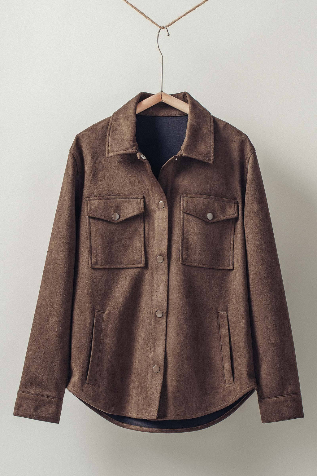 Faux suede button-up shacket in rich brown, featuring chest pockets and a curved hem, perfect for stylish layering in Long Island boutique fashion.