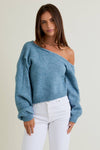 Soft, light blue asymmetrical shoulder sweater top with a relaxed fit and ribbed hem, perfect for casual outings in Long Island boutique fashion.
