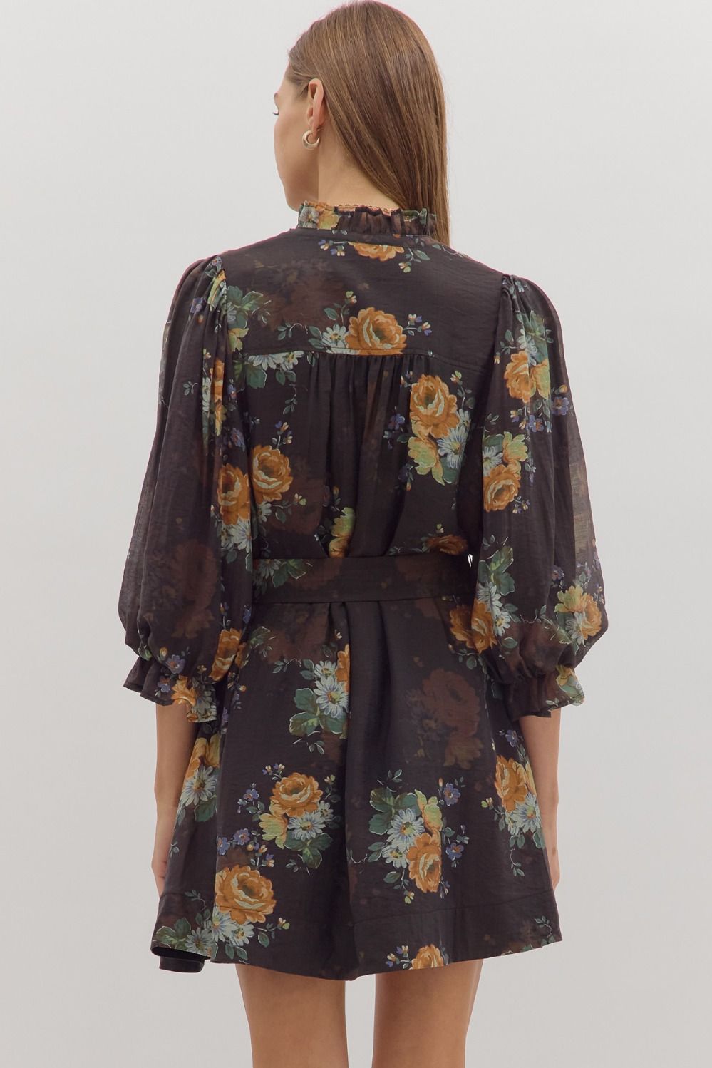 Floral print mini dress featuring 3/4 puff sleeves, a fitted waist with a bow tie, and a dark background, perfect for Long Island boutique fashion.
