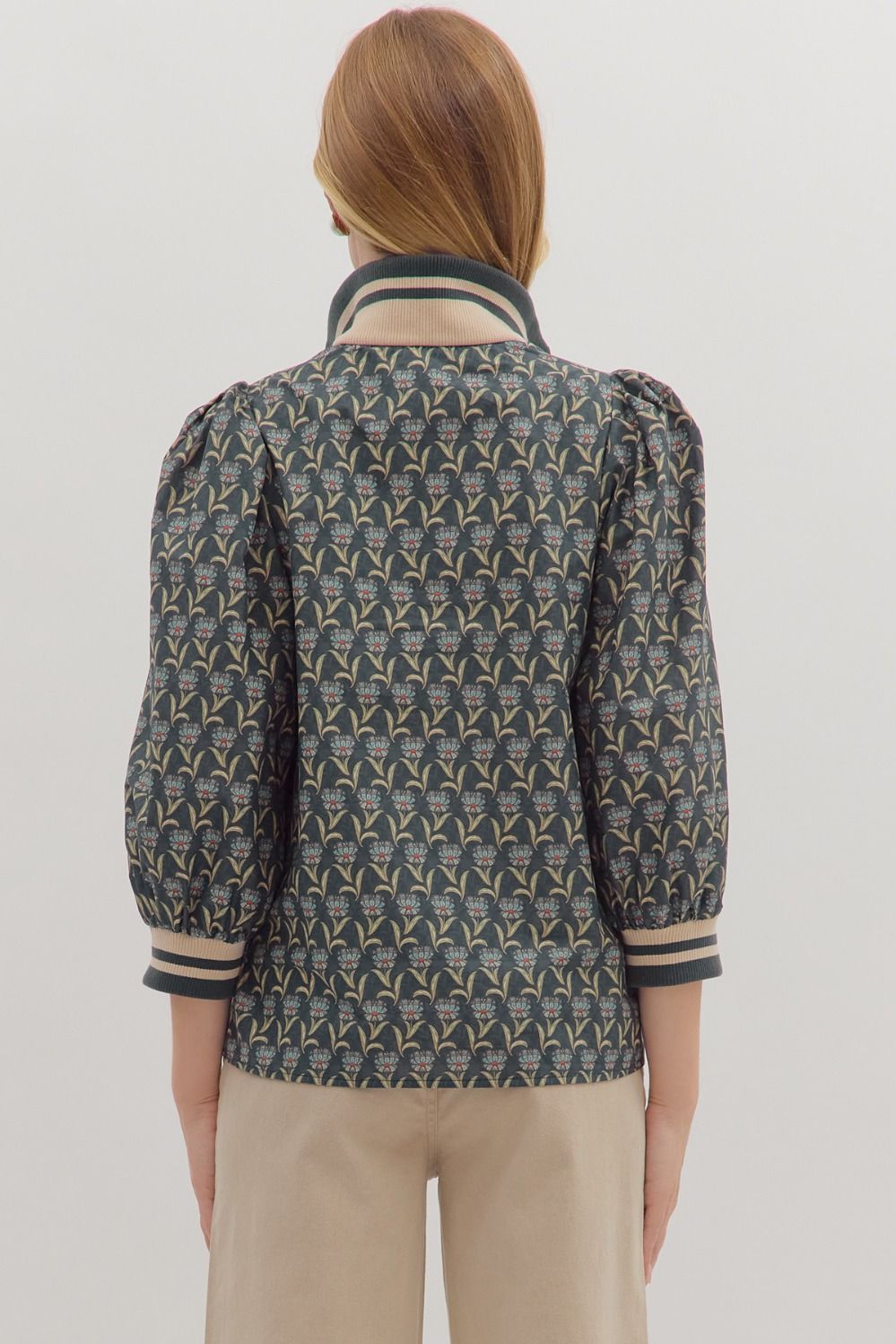 Floral print 3/4 sleeve top in dark blue features a trendy zip neck, puff sleeves, and striped detailing, ideal for Long Island boutique fashion.