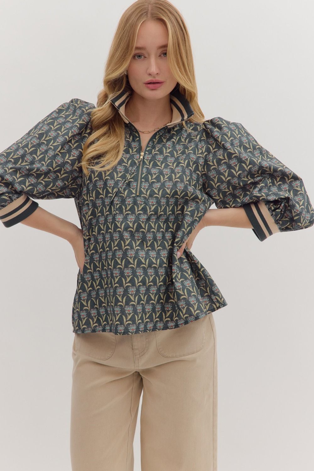 Floral print 3/4 sleeve top in dark blue features a trendy zip neck, puff sleeves, and striped detailing, ideal for Long Island boutique fashion.