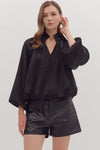 Chic black balloon sleeve V-neck top with a textured finish, perfect for trendy Long Island boutique fashion.