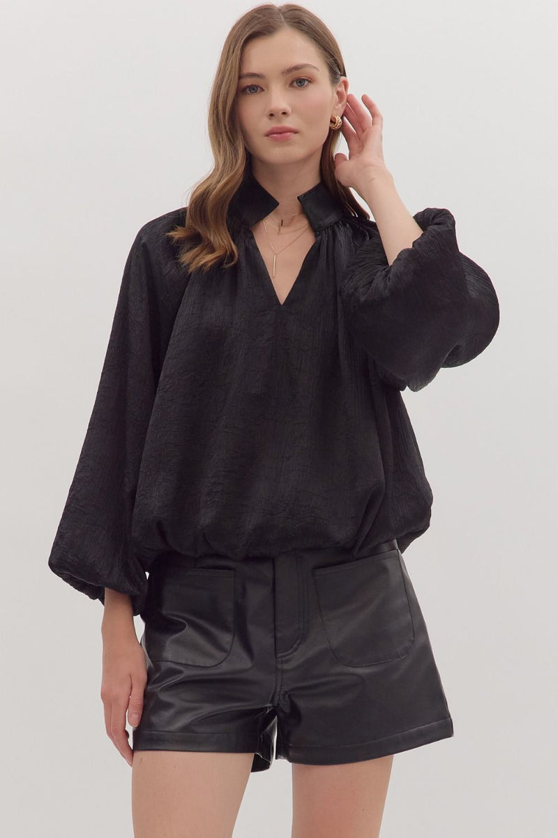 Chic black balloon sleeve V-neck top with a textured finish, perfect for trendy Long Island boutique fashion.