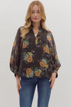Relaxed floral print puff sleeve top featuring warm orange and green blooms against a dark background, ideal for Long Island boutique fashion.