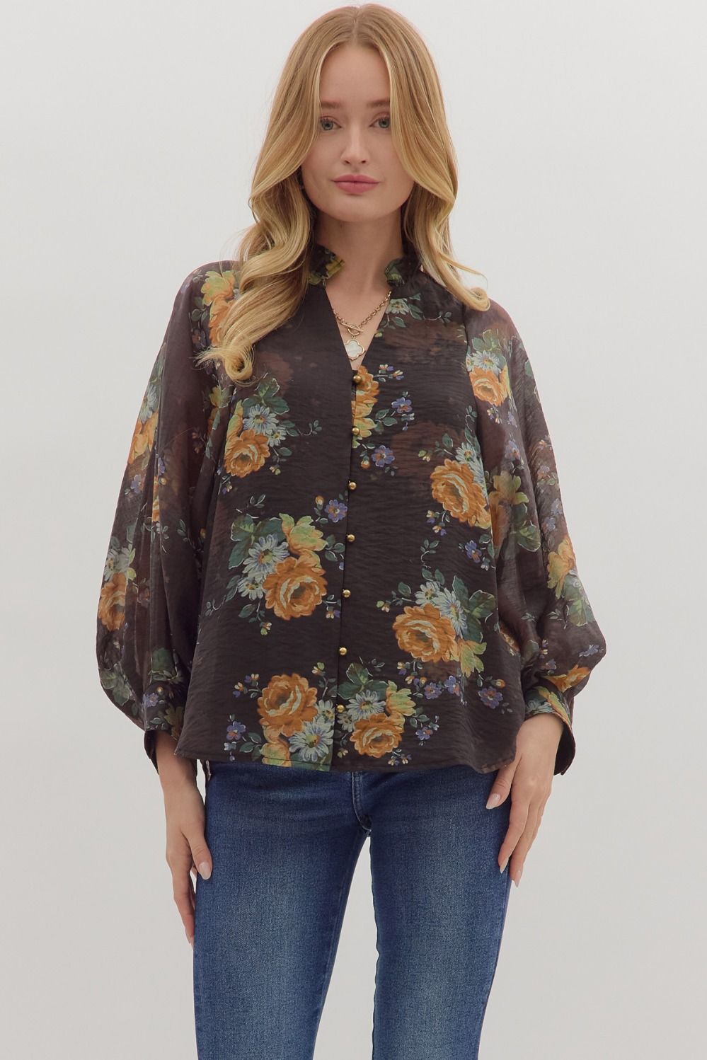 Relaxed floral print puff sleeve top featuring warm orange and green blooms against a dark background, ideal for Long Island boutique fashion.