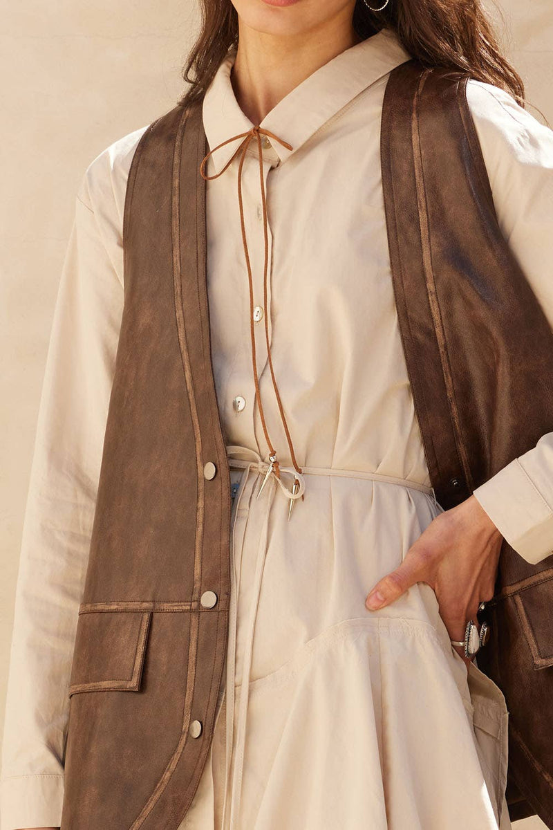 Faux leather snap-front vest in rich brown with a relaxed fit, perfect for layering, ideal for Long Island boutique fashion.
