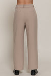 Light beige front pleat detail pants with a wide leg fit and subtle back pockets, perfect for stylish Long Island boutique fashion.