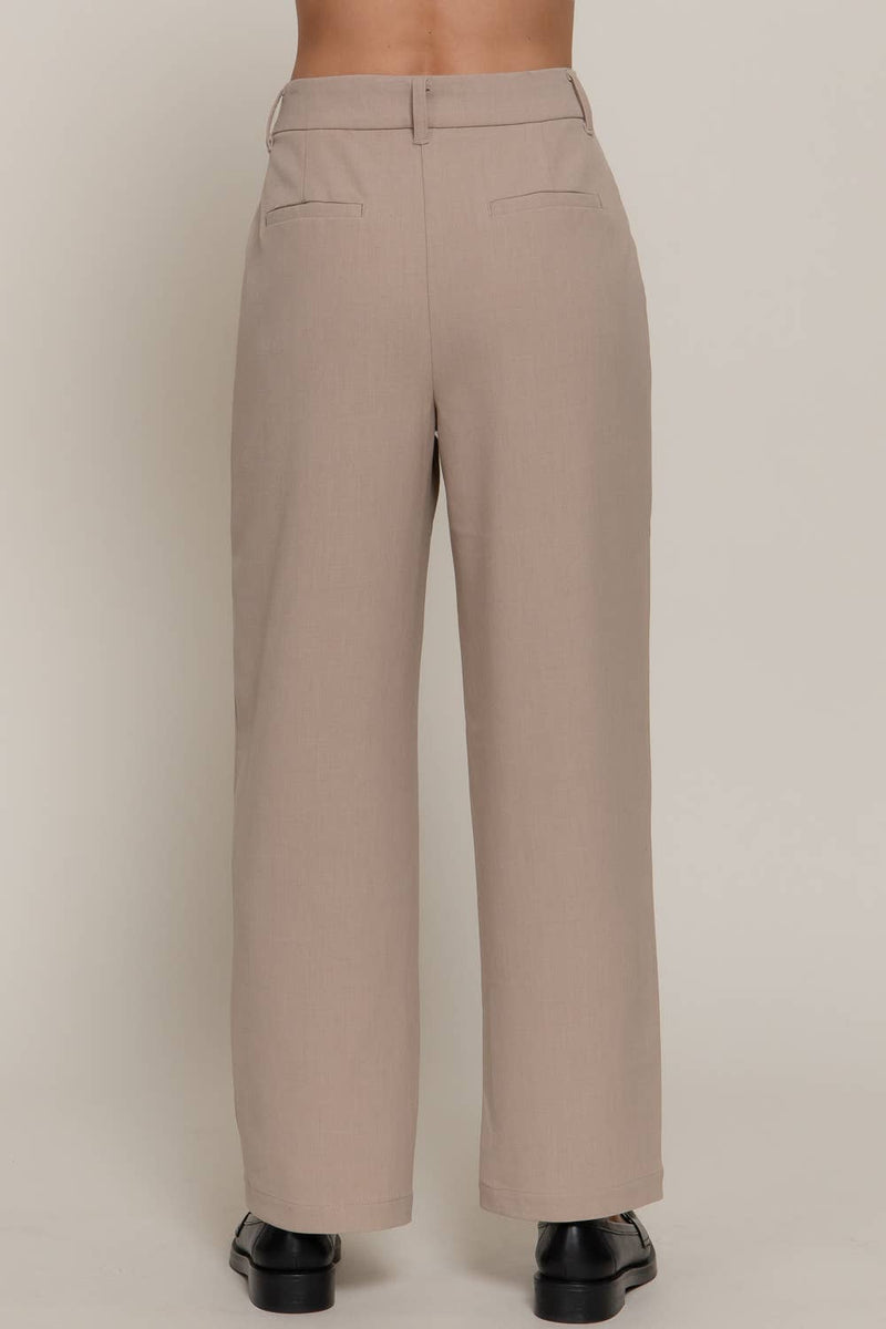 Light beige front pleat detail pants with a wide leg fit and subtle back pockets, perfect for stylish Long Island boutique fashion.