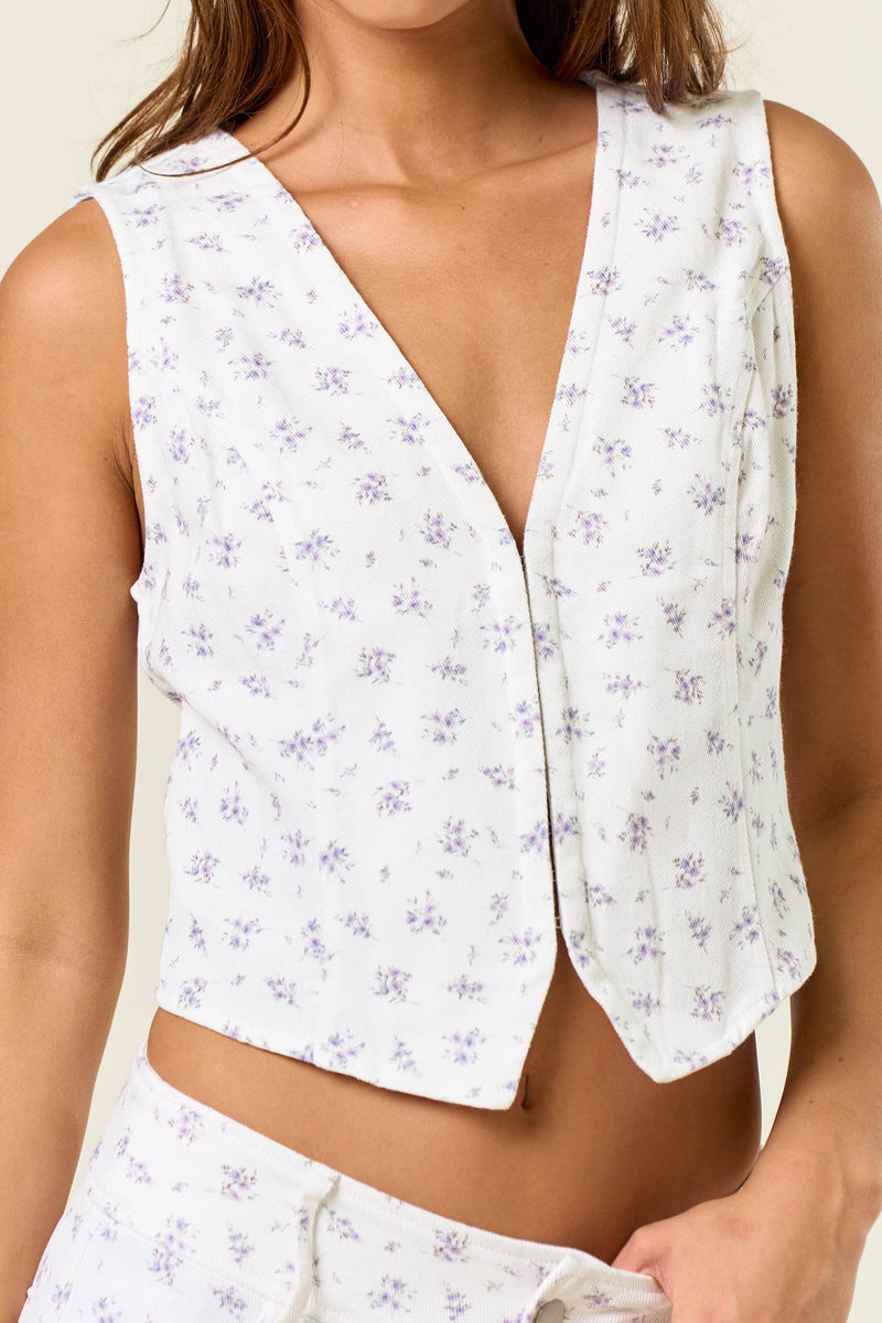 White floral ditsy vest top with a hook and eye closure and a relaxed fit, perfect for Long Island boutique fashion styles.