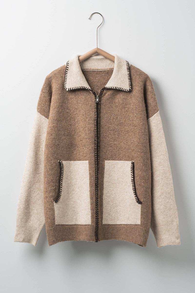 Cozy colorblock cardigan featuring a rich brown and cream design, contrast stitching, and front pockets, perfect for Long Island boutique fashion.