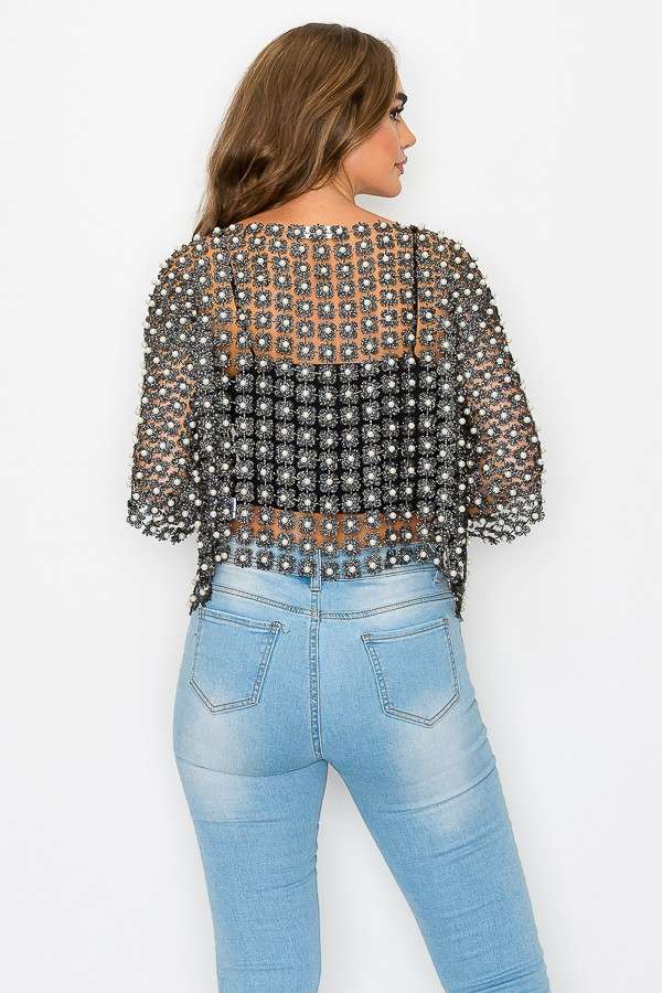 Chic black crochet cardigan adorned with shimmering beads, featuring a relaxed fit and short sleeves, perfect for Long Island boutique fashion.