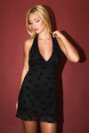 Chic halter neck mini dress in black, featuring floral patterns and a delicate ruffled hem, perfect for Long Island boutique fashion.