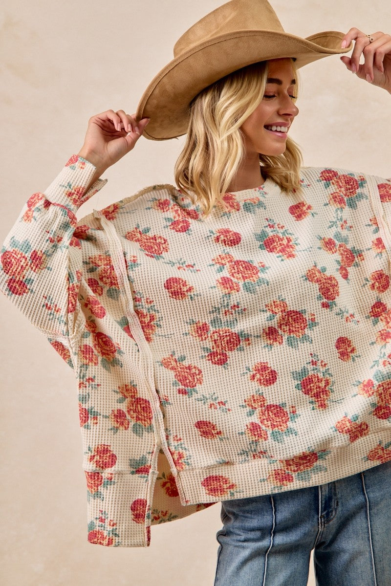 Soft oversized waffle thermal sweatshirt featuring a floral print in warm tones, perfect for a cozy Long Island boutique fashion look.