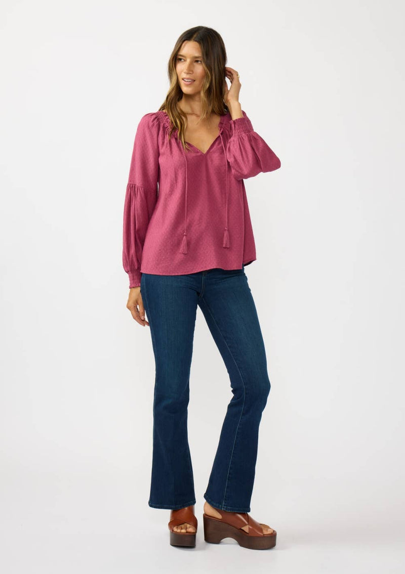 Soft mauve Bishop Raglan long sleeve boho top features a v-neckline, elastic puff sleeves, and delicate tassel details, perfect for Long Island boutique fashion.