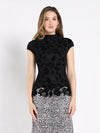 Elegant black floral lace front top with cap sleeves and mock neck, perfect for layering in any Long Island boutique fashion wardrobe.