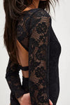 Lace long-sleeve bodysuit in black with floral patterns and a stylish open back, perfect for chic Long Island boutique fashion.
