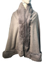 Soft gray faux fur poncho cape with a plush collar and detailed edging, perfect for layering in Long Island boutique fashion.