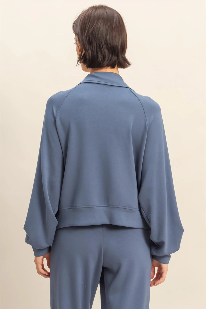 Soft blue half zip high neck collar sweatshirt with balloon sleeves, ideal for cozy layering in Long Island boutique fashion.