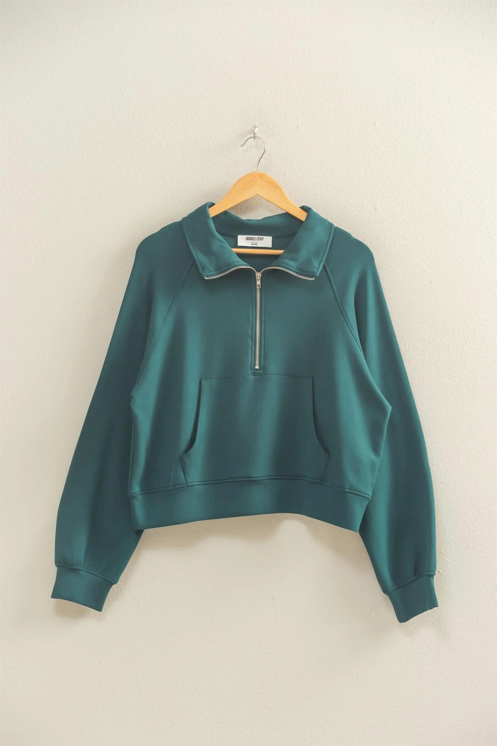 Teal half zip high neck collar sweatshirt with a relaxed fit and front pocket, perfect for cozying up in Long Island boutique fashion.