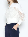 Elegant white Gracia lace zip-up top featuring sheer lace sleeves and a fitted silhouette, perfect for Long Island boutique fashion.