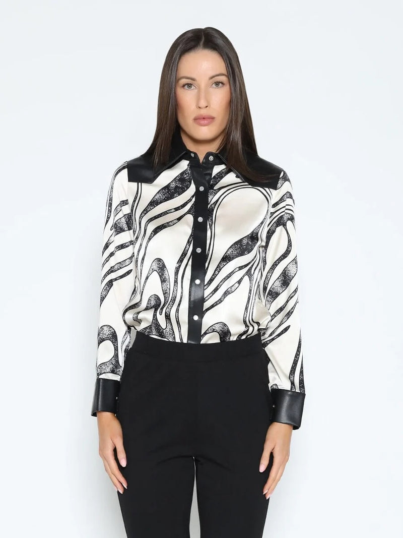Stylish button-down shirt with a wavy black and white print, featuring pleather splicing and a chic collar, perfect for Long Island boutique fashion.