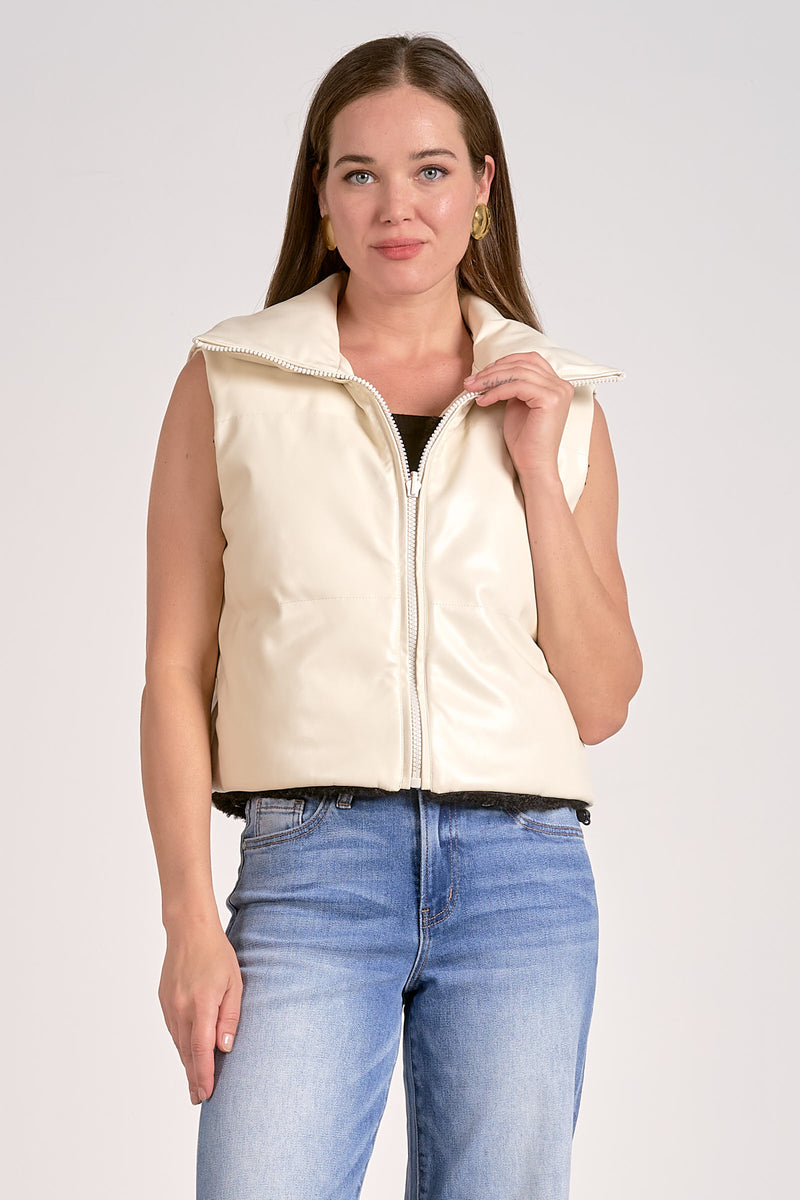 Reversible cream Elan vest featuring a high collar, zip front, and sleeveless design, perfect for stylish layering in Long Island boutique fashion.