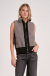 Sleeveless zip-up vest in plush gray fabric with black accents, perfect for layering in stylish Long Island boutique fashion.