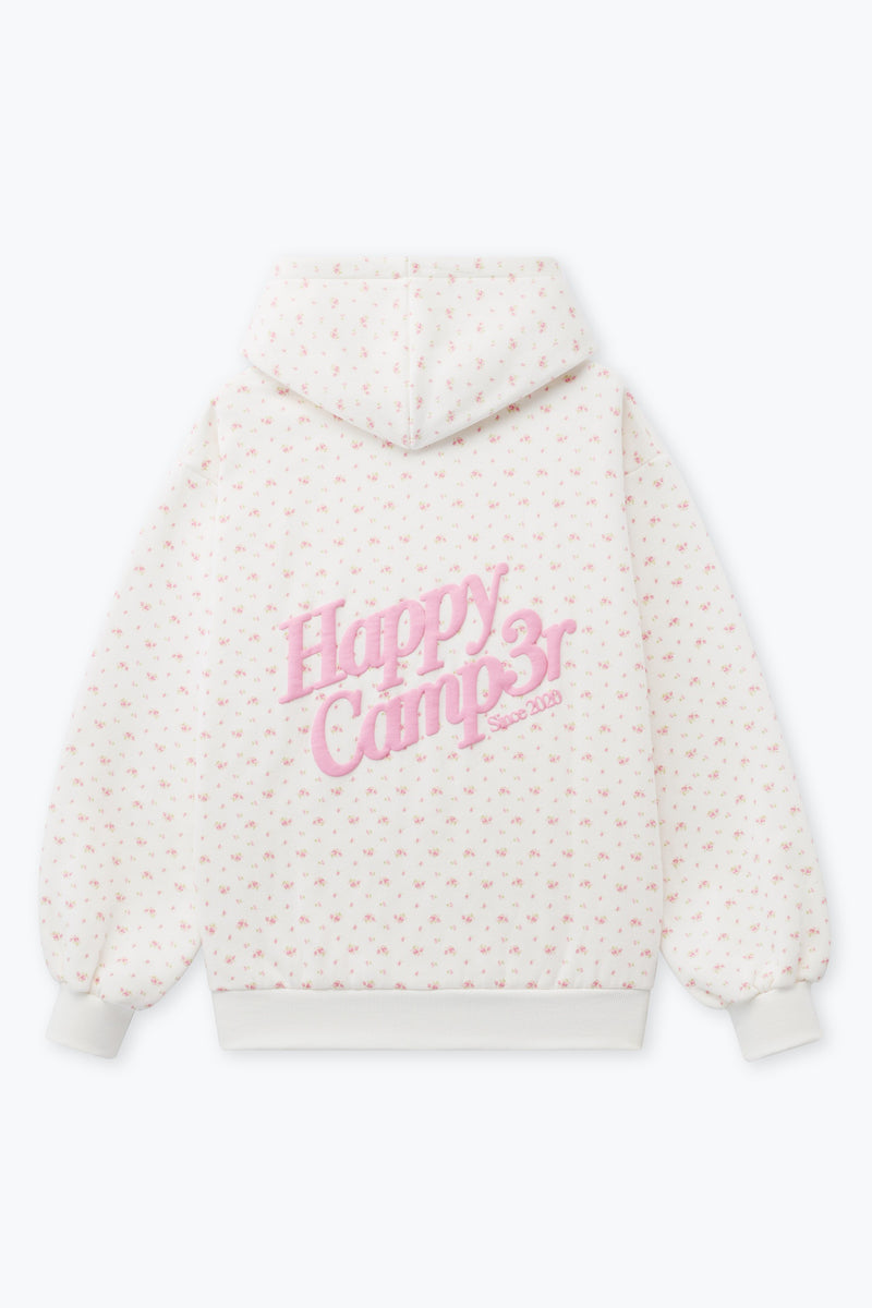 Cozy white hoodie featuring a pink floral pattern and "Happy Camp3r" embroidery, perfect for Long Island boutique fashion lovers.