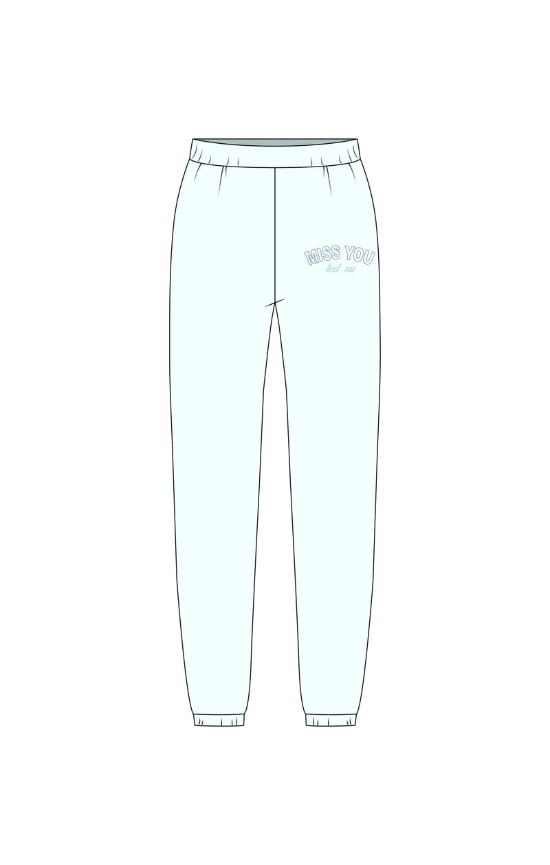 Light blue joggers featuring a comfortable elastic waistband and "MISS YOU" graphic, perfect for relaxed style from a Long Island women’s boutique.