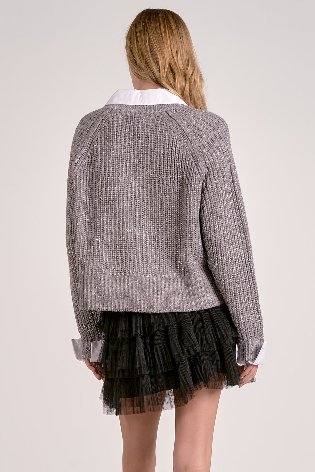 Soft gray V-neck sweater with sequin details and a stylish collar, paired with a black layered tulle skirt, perfect for Long Island boutique fashion.