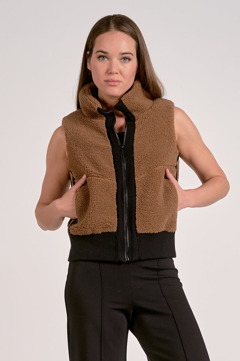 Cozy brown zip-up vest with a plush texture and contrasting black hem, perfect for layering in Long Island boutique fashion.
